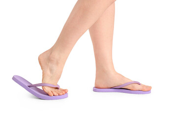 Female legs in flip-flops on white background