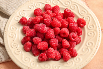 Plate with fresh raspberries, closeup
