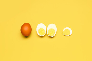 Tasty boiled eggs on yellow background