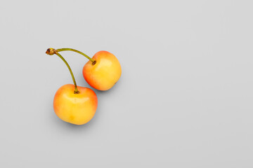 Sweet yellow cherries on grey background