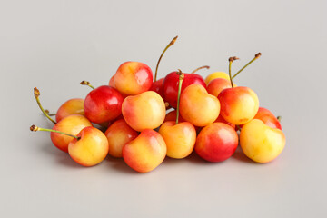 Heap of sweet yellow cherries on grey background © Pixel-Shot