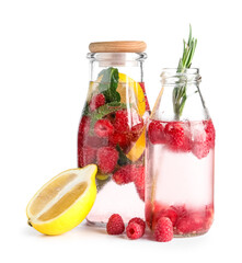 Bottles of fresh raspberry lemonade with mint and rosemary on white background