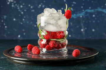 Glass of fresh raspberry lemonade with rosemary on dark table