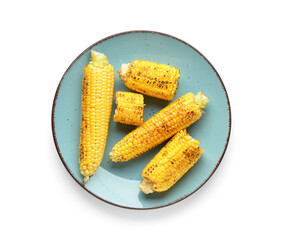 Plate with tasty grilled corn cobs on white background