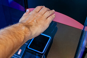 Man scanning his palm to pay in the store. Modern wireless payment technology