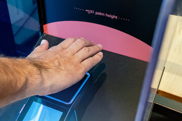 Man scanning his palm to pay wireless, futuristic payment technology