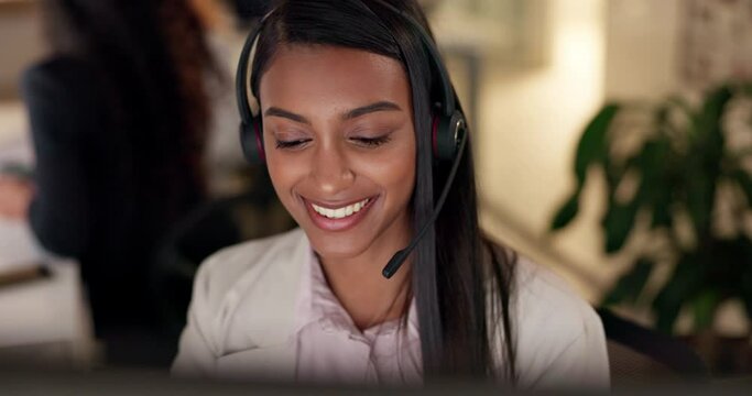 Face, call center and a woman talking with a headset at night for customer service, advice or crm. Happy Indian person working at office for telecom, telemarketing or technical support at help desk