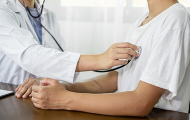 The female doctor measured blood pressure, the patient examined the heartbeat and sat down to talk about health care closely. health care concept