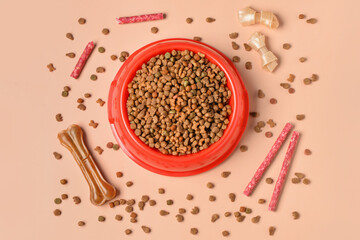 Composition with bowl of dry dog food and different treats on color background