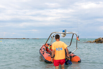 Fototapeta premium Lifeguard approaching to a rescue boat on the sea