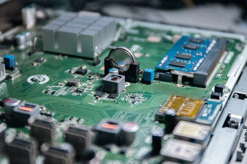 CMOS backup battery CR2032,Pci-express,SATA Port, circuit on a modern black motherbord. Computer...