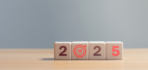 Wooden blocks with text 2025 on wooden table with white background. new year goals Action plan....
