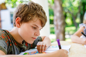 Preteen School Boy Drawing with Felt Pens. Back to School. Caucasian Little Schoolboy Drawing Picture at Home. Hobby, Education Concept.