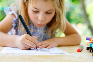 Cute Little Preschooler Child Drawing at Home. Happy Girl with Colorful Felt Pens. Hobby for...