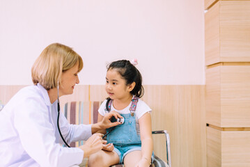 Asian child getting health check from doctor at hospital,Medical examination concept
