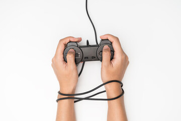 Video Game Addiction. Wire and gamepad or joystick, wired hands with joypad meaning © jittawit.21