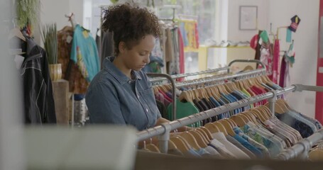 Female Shopping for Vintage Clothes in Second hand Store