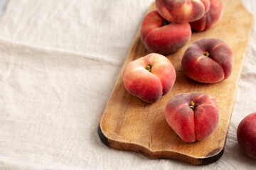 Organic Donut Saturn Peaches on a rustic wooden board, side view. Copy space.