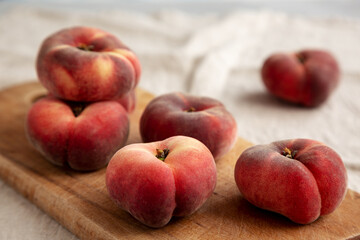 Organic Donut Saturn Peaches on a rustic wooden board, side view. Close-up.