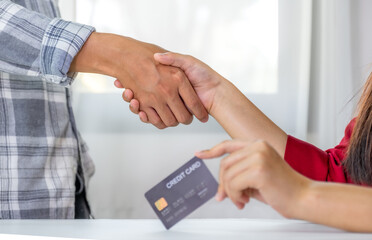 handshake. Young couple consumer holding mock up credit card, Ready to spend pay online shopping according to discount products via smartphone and laptop from home office
