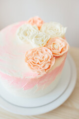 Birthday celebration for girl at home in light pink and gold colors. Birthday cake with flowers