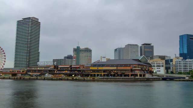 Moving timelapse at Kobe city Osaka cloudy day at Harbourfront panning shot ships passing by