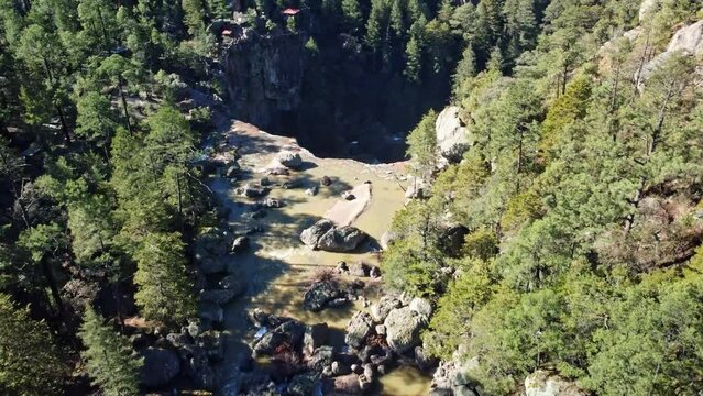 Tilt down aerial drone shot on the river of the Cusarare Waterfall, Chihuahua