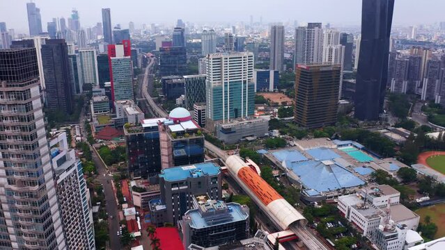 GOR Sumantri Bus Stop Near Directorate General of Immigration Building And Sumantri Sports Centre Kuningan In Jakarta, Indonesia. aerial pan left