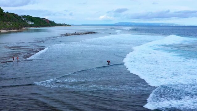 Gunung Payung Beach With Tourists In Bali, Indonesia - drone shot