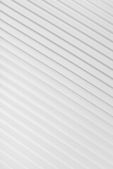 White abstract background of diagonal parallel lines pattern with gradient light, top view, backdrop for advertising, design, card, poster, flyer, text, elegant soft futuristic geometric style.