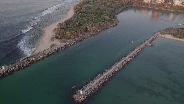 Mooloolaba And Point Cartwright Rock Walls On The Mouth Of Mooloolah River At Dusk In Queensland, Australia. aerial pan right