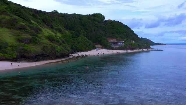Tourist At The Secluded Beach Of Gunung Payung Near Pandawa Beach In Kuta Selatan , Badung , Bali, Indonesia. Aerial Drone Shot