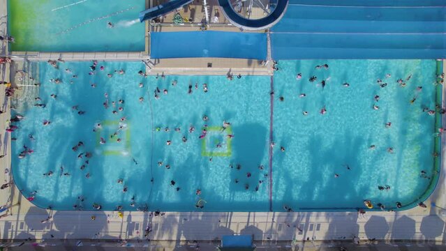 Top down view of children enjoying the pools during the summer