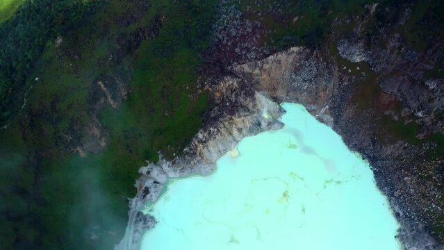Top View Of The Famous Kawah Putih Or White Crater In Bandung, West Java, Indonesia - aerial drone shot