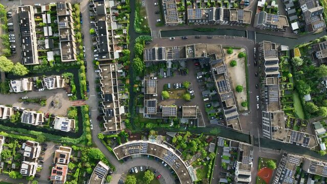 Top down aerial view of housing project with condos, apartments, and parking