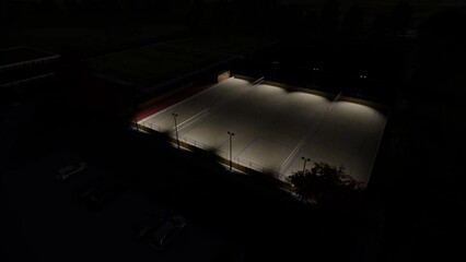 Aerial video rendering of a beach volleyball court at night