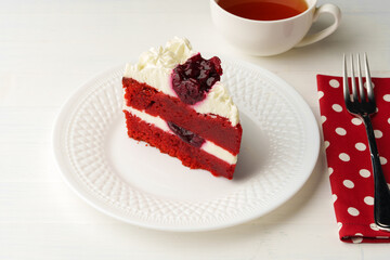 Piece of red velvet cake on white table
