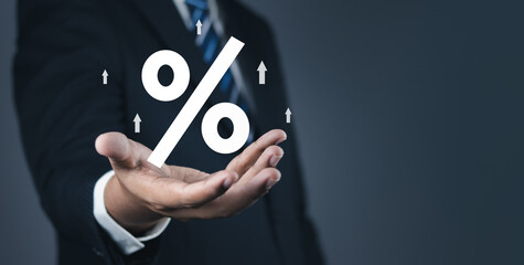 Concept of financial interest rates and dividends provision of financial services.Businessman showing percentage icons and up arrow icons. Interest Rates Stocks Finance Ratings Mortgage Rates.