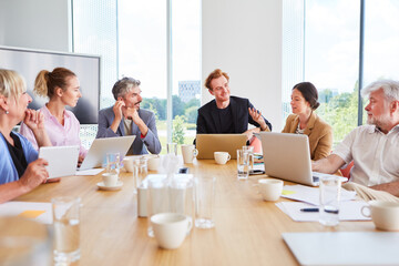 Confident team of business professionals having team meeting in conference room of office