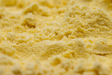 Pile of corn flour as background, spice or seasoning as background. close-up cornmeal