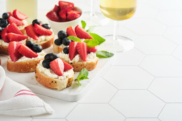 American flag sandwich with strawberries, blueberries, whipped sweet cream, soft cheese on toast bread. 4th of July American Independence Day food. Independence or Patriotic Day breakfast idea Mock up