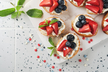 American flag sandwich with strawberries, blueberries, whipped sweet cream, soft cheese on toast bread. 4th of July American Independence Day food. Independence or Patriotic Day breakfast idea Mock up