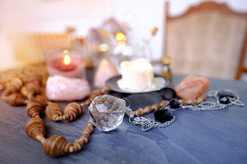 esoteric table, glass ball crystal, candles burn, concept of magic, witchcraft, offering guidance and wisdom, evoking sense of mystery and intrigue in quest for answers and enlightenment