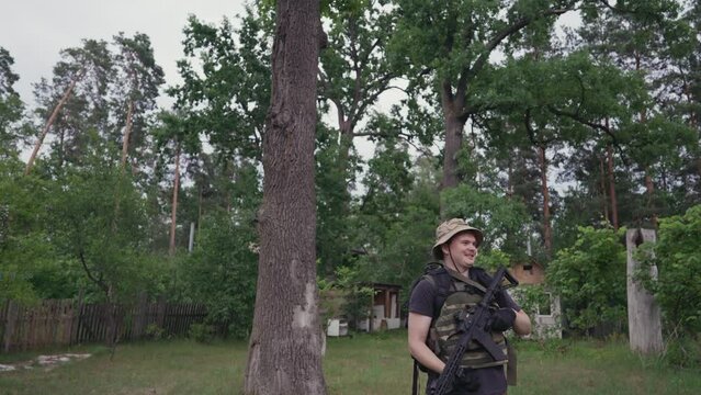A man with a gun in a light military uniform