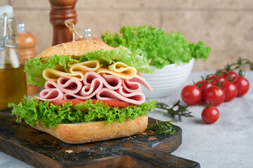 Sandwich. Tasty sandwich with ham or bacon, cheese, tomatoes, lettuce and grain bread. Delicious club sandwich or school lunch, breakfast or snack.