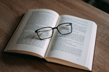 Glasses and books placed on table in the living room .Educational concepts and knowledge
