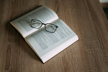 Glasses and books placed on table in the living room .Educational concepts and knowledge
