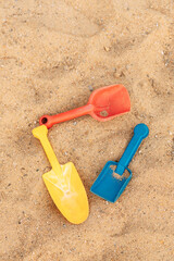 Fototapeta na wymiar children's paddles in the sand
