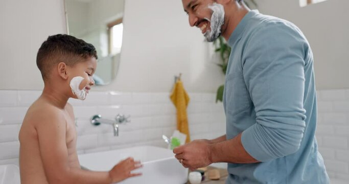 Learning about shaving cream, kid and dad teaching skincare in family bathroom with son in the morning. High five, grooming and happy child and parent relax or play with foam together at home