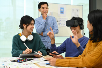 Innovation, technology and futuristic concept. Developers team brainstorming, testing virtual reality simulator glasses at meeting
